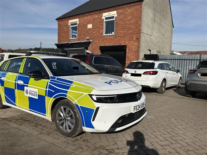 A marked police vehicle in front of the abattoir