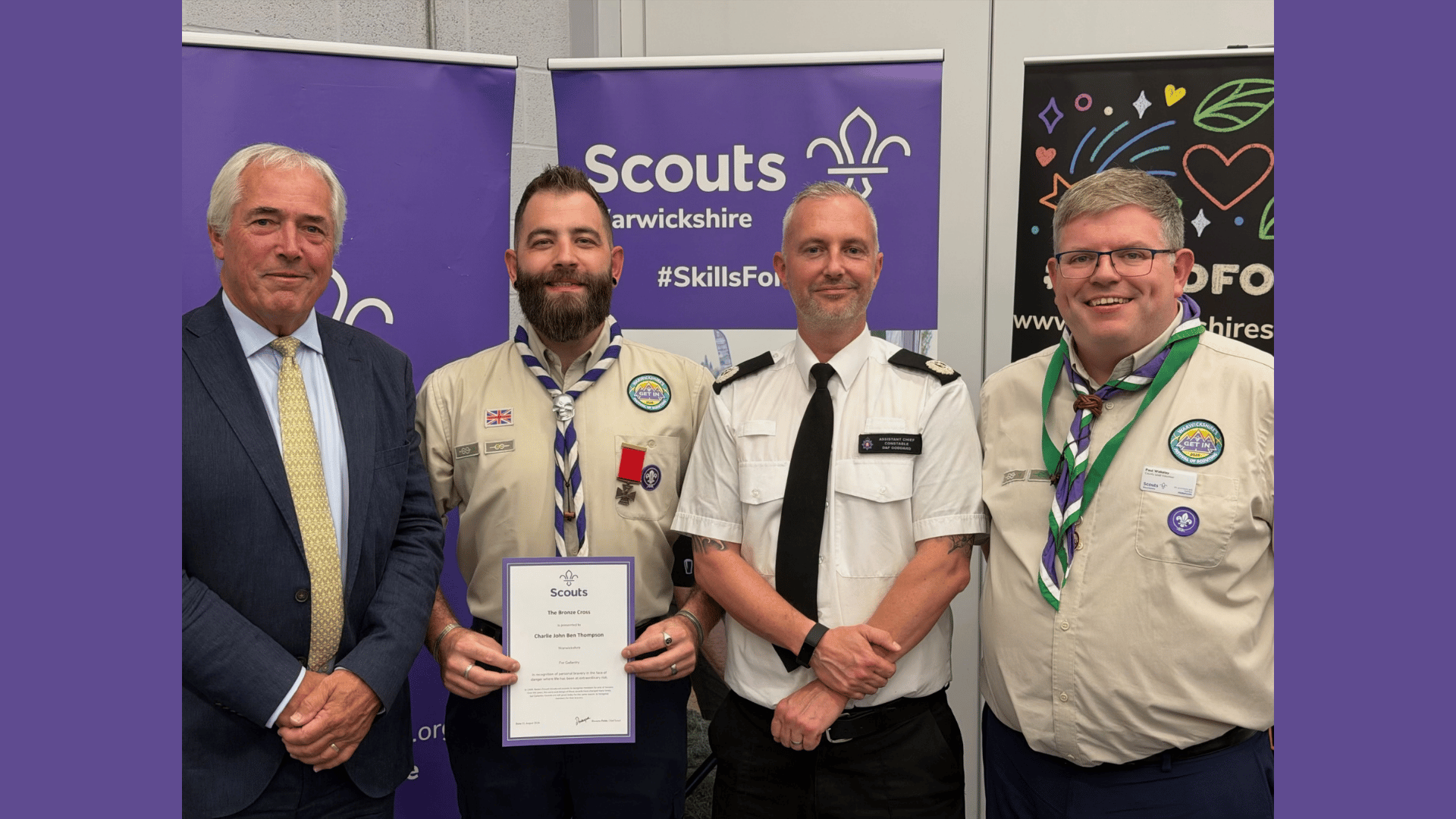 Charlie Thompson is pictured receiving his Bronze Cross, with Tim Cox, Lord Lieutenant of Warwickshire (l), Assistant Chief Constable Dafydd Goddard of Warwickshire Police, and Paul Wakeley, County Lead Volunteer for Warwickshire Scouts (r)