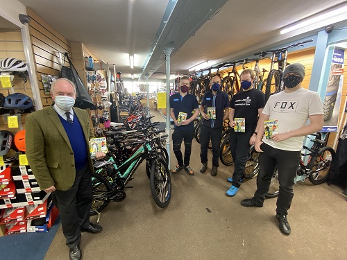 Warwickshire Police and Crime Commissioner handing over copies of the Ultimate Guide to Cycling magazines at John Atkins Cycles in Leamington Spa